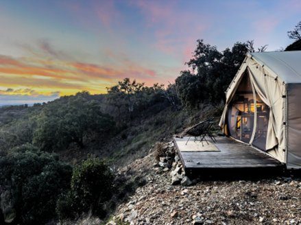 The Safari tent on its deck at dusk, overlooking the valley